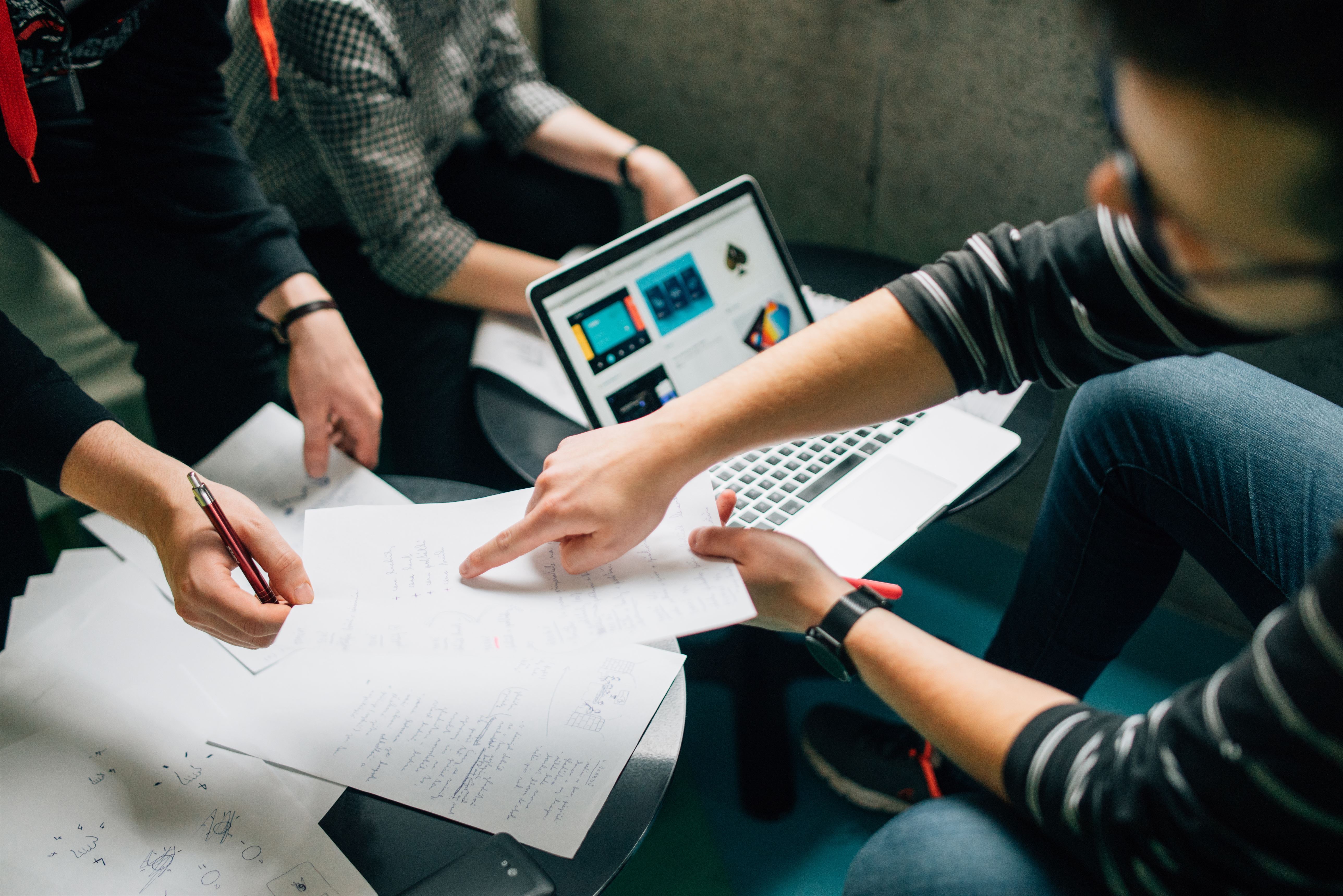 Group of individuals working on solving a problem 